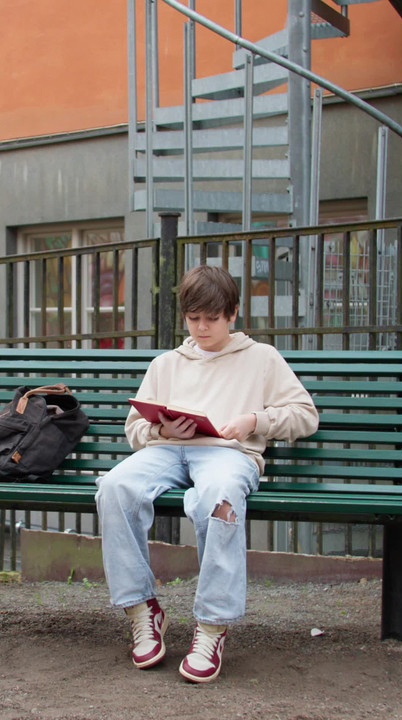 A child reading on a bench