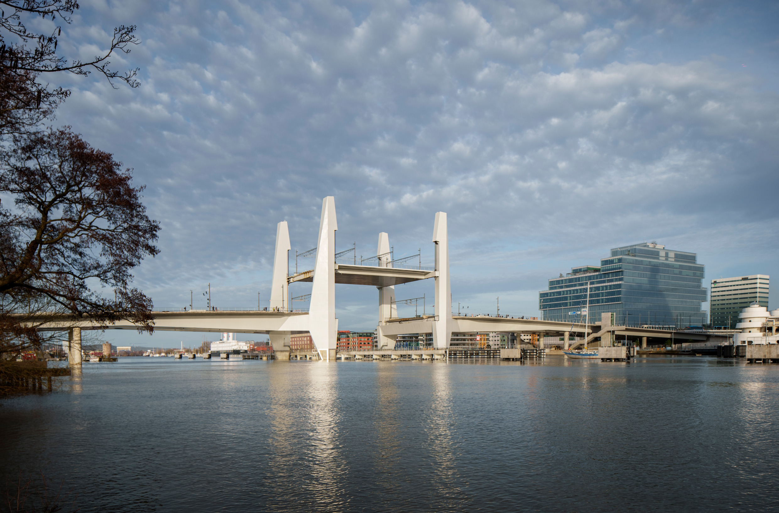 A large bridge with a city in the background.