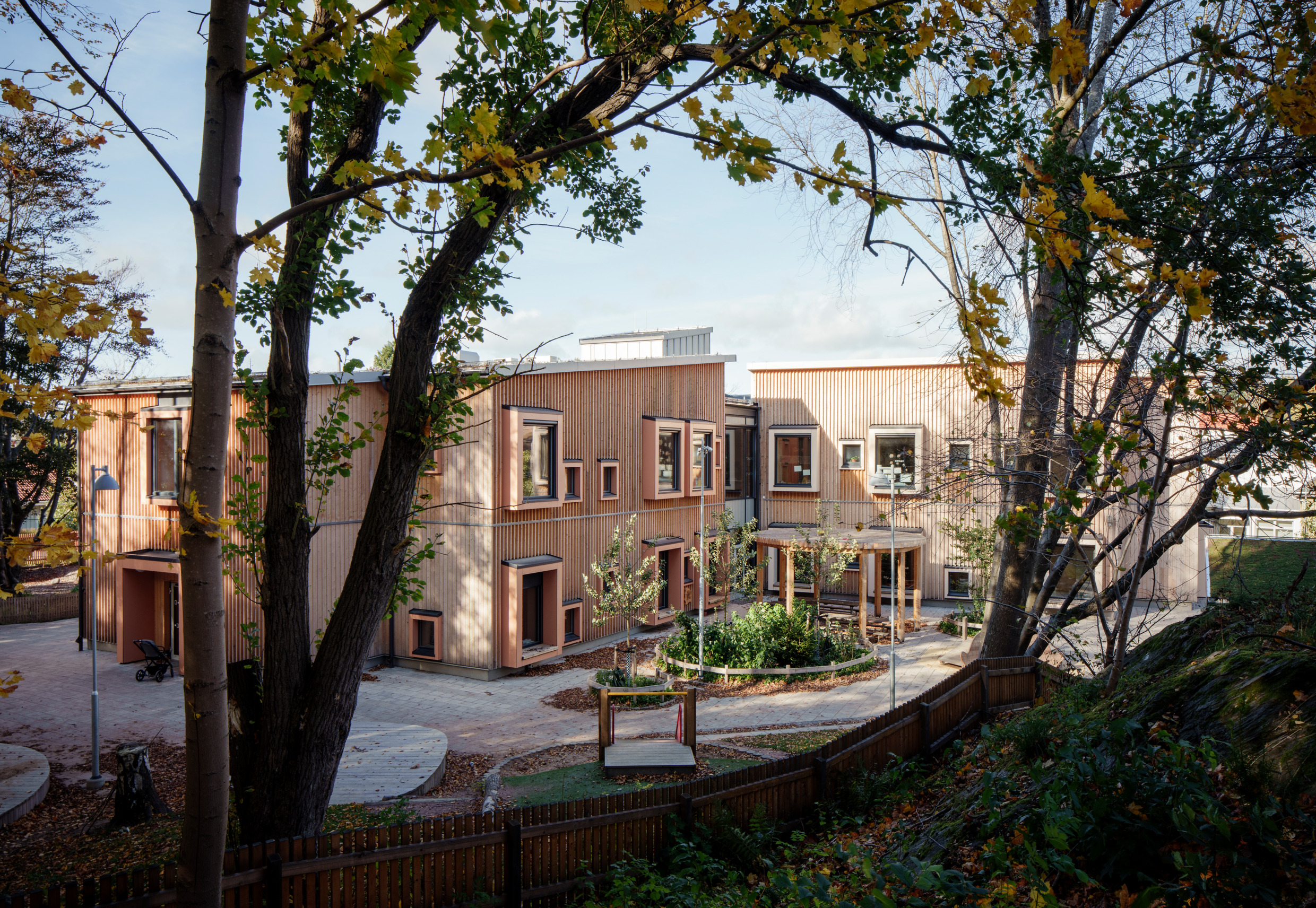 Wooden buildings seen through trees.