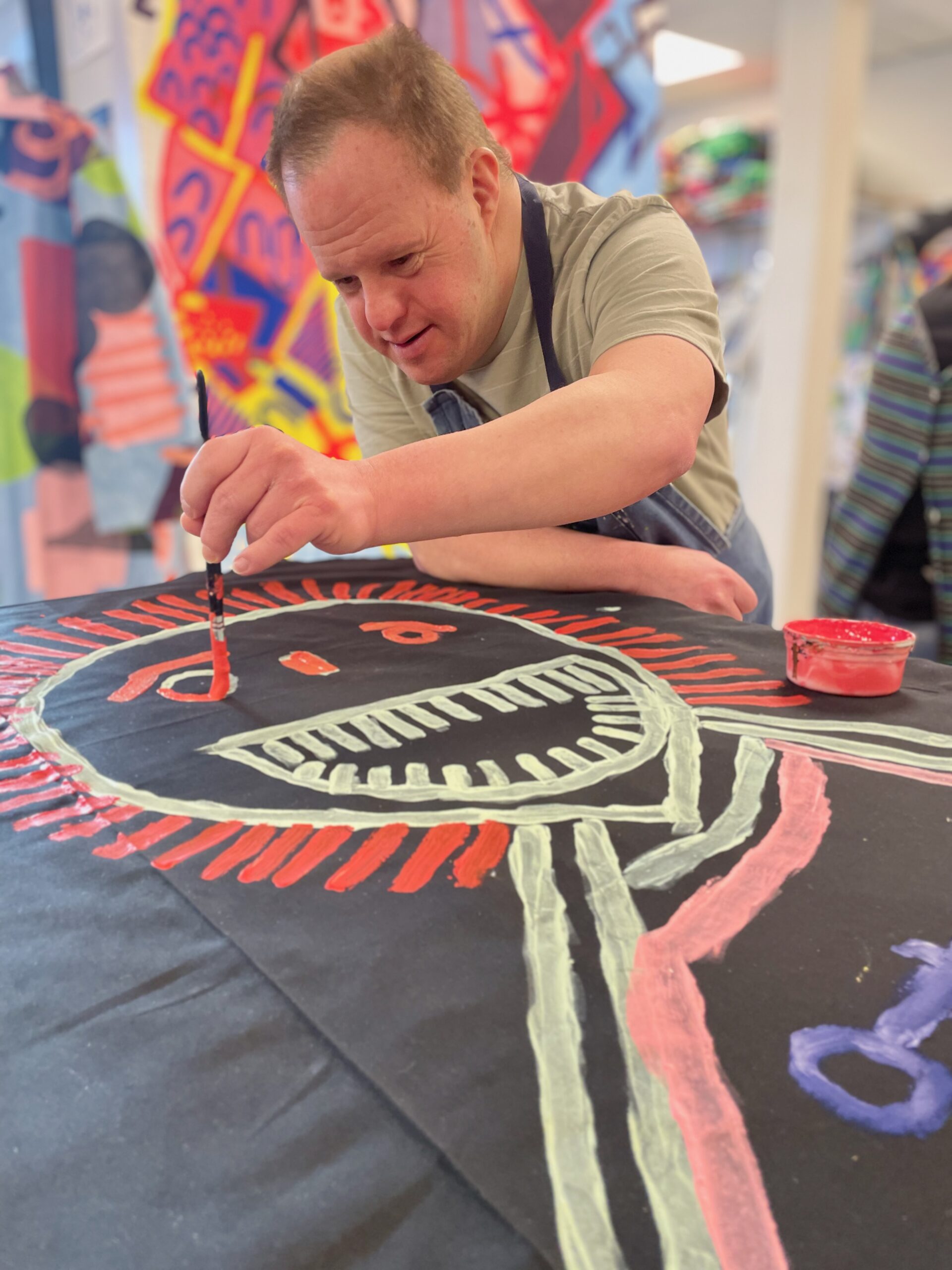 A man with Downs syndrom creating textile art.